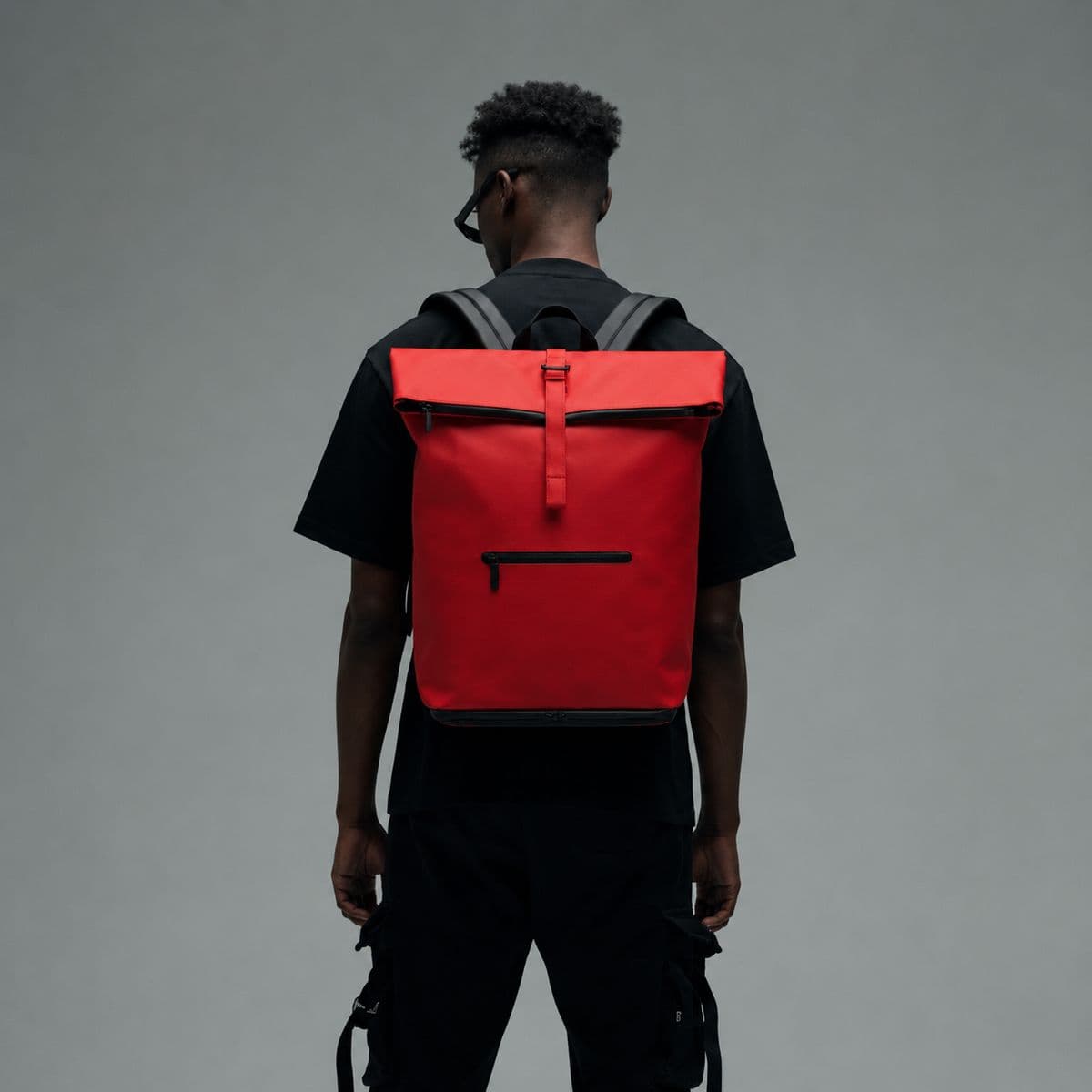 Model wearing NORJ red backpack